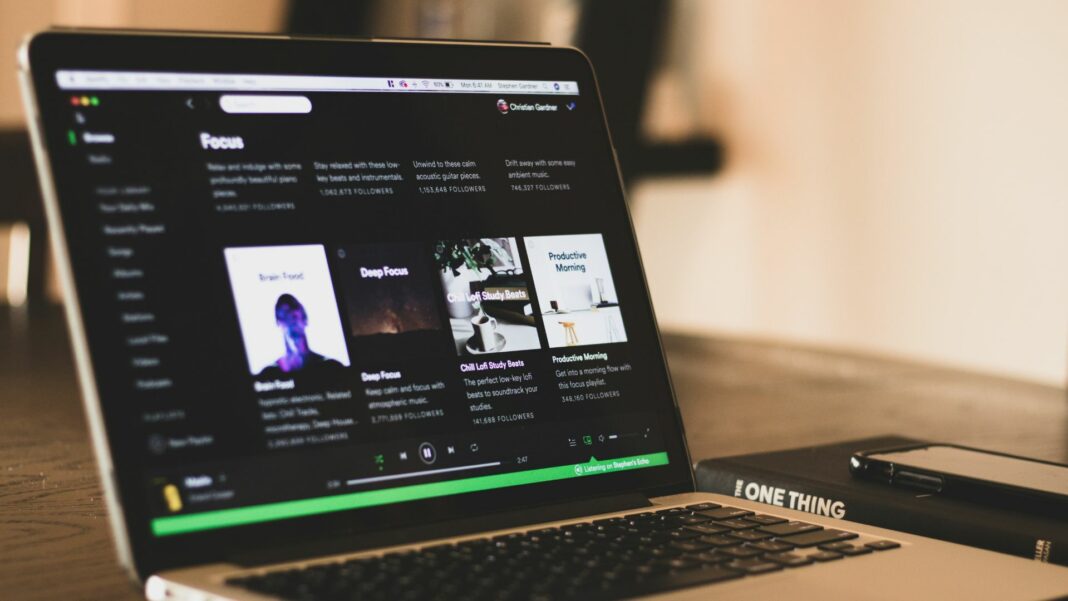 A computer displays the Spotify website.